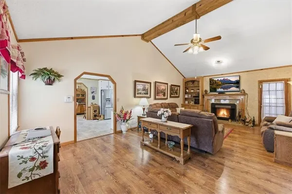 a living room with furniture a flat screen tv and a fireplace