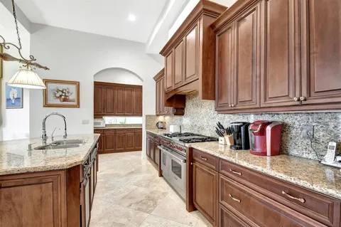 a bathroom with a granite countertop sink a mirror and a shower