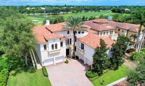 a room with furniture pool table and windows
