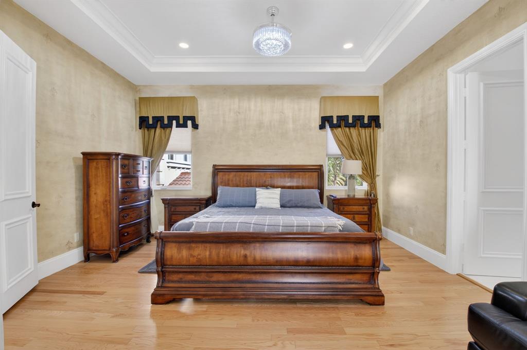 6453 Montesito Street Boca Raton, FL 33496 - Photo 21 of 60 a bedroom with furniture and wooden floor