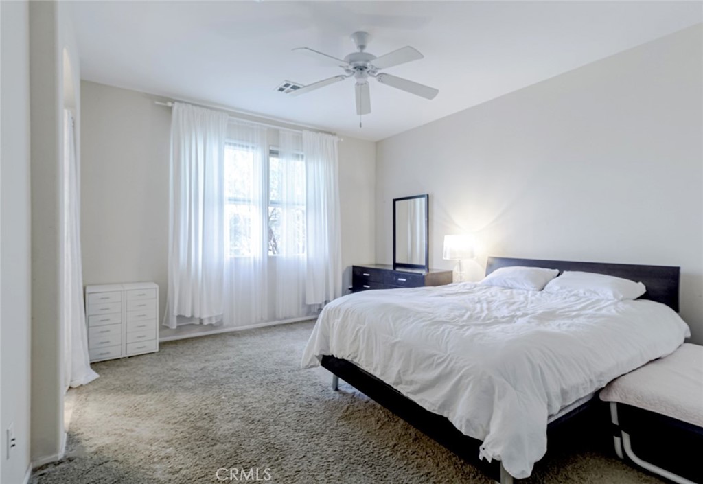 25562 Huxley Drive Stevenson Ranch, CA 91381 - Photo 11 of 24 a bedroom with a bed and window