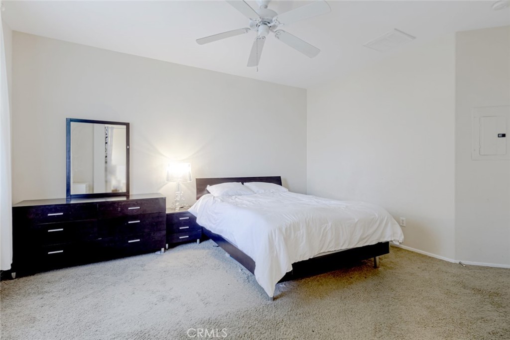 25562 Huxley Drive Stevenson Ranch, CA 91381 - Photo 12 of 24 a bedroom with a bed and a dresser