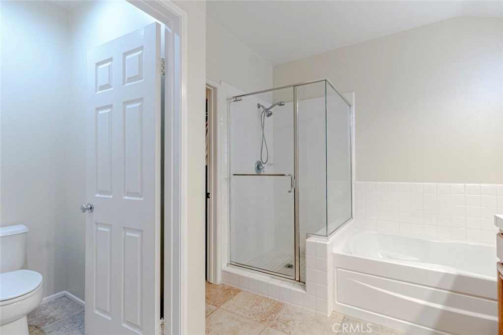 25562 Huxley Drive Stevenson Ranch, CA 91381 - Photo 14 of 24 a bathroom with a bathtub and a shower