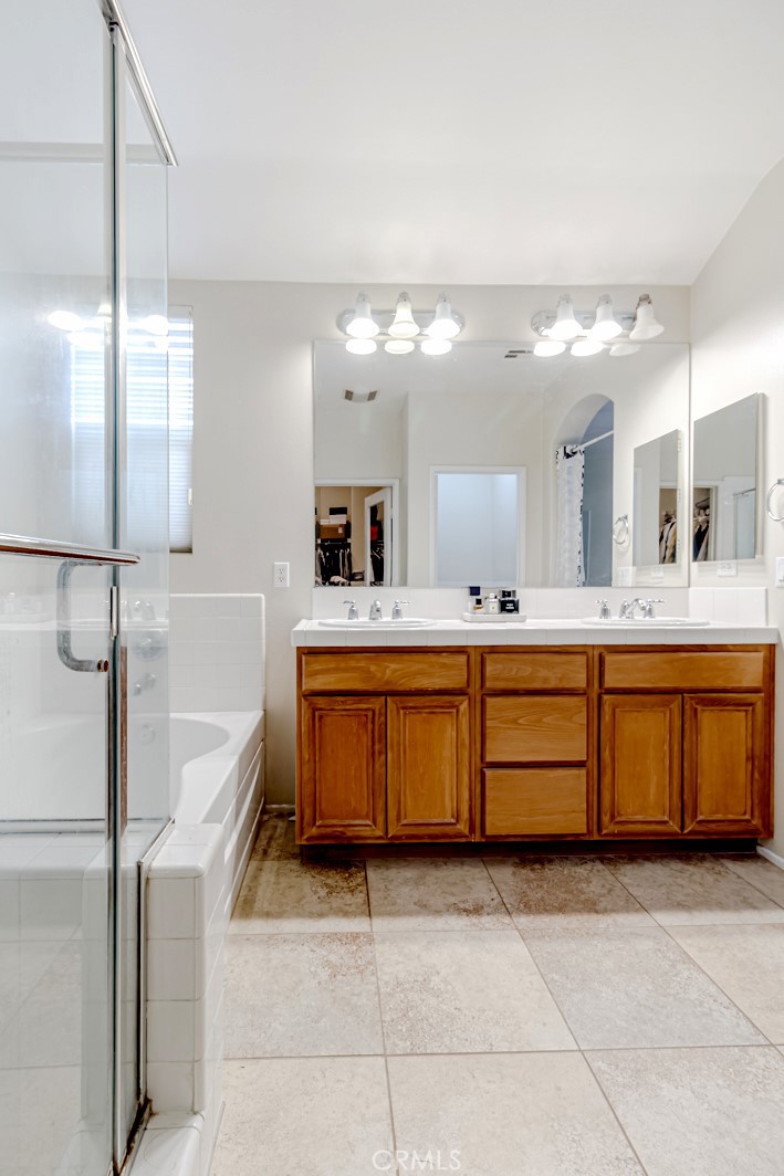25562 Huxley Drive Stevenson Ranch, CA 91381 - Photo 15 of 24 a bathroom with a sink double vanity and a mirror