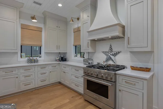 a kitchen with stainless steel appliances granite countertop a stove and a sink