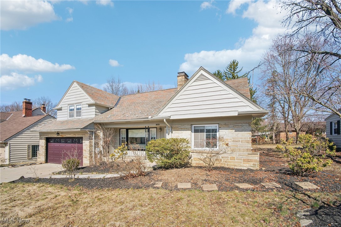 1445 Westover Road Cleveland, OH 44118 - Photo 2 of 47 Front of home with stone facade, slate roof, two-car garage, and yard