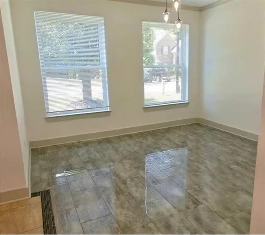 a kitchen with stainless steel appliances kitchen island granite countertop a sink a stove a refrigerator a dining table and chairs