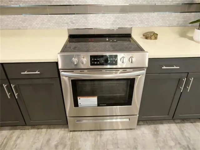 an empty room with wooden floor and a window
