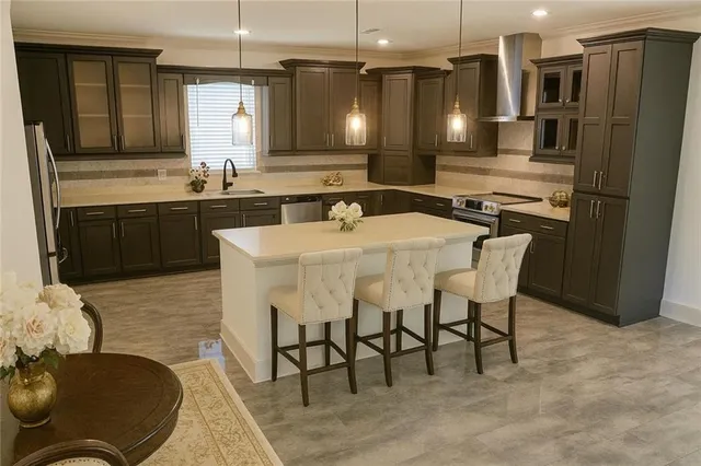 an empty room with wooden floor chandelier and windows