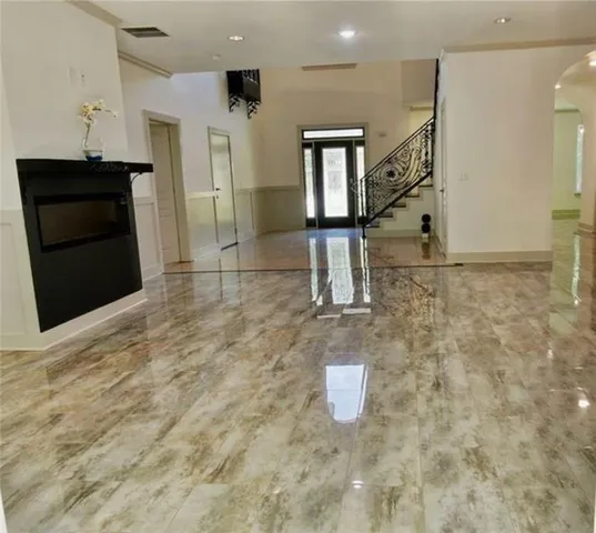 a bedroom with a bed a lamp and a window