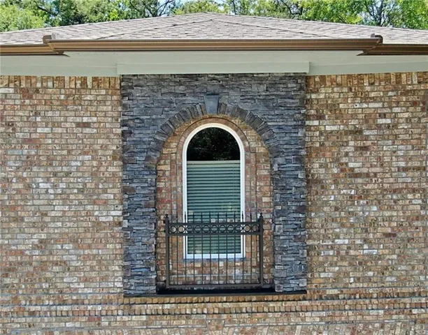 a view of a patio with chairs and wooden fence