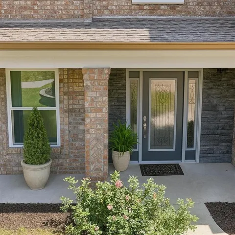 a living room with furniture and painting on the wall