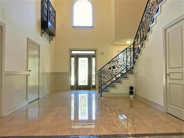 a bathroom with a granite countertop sink a toilet and a mirror