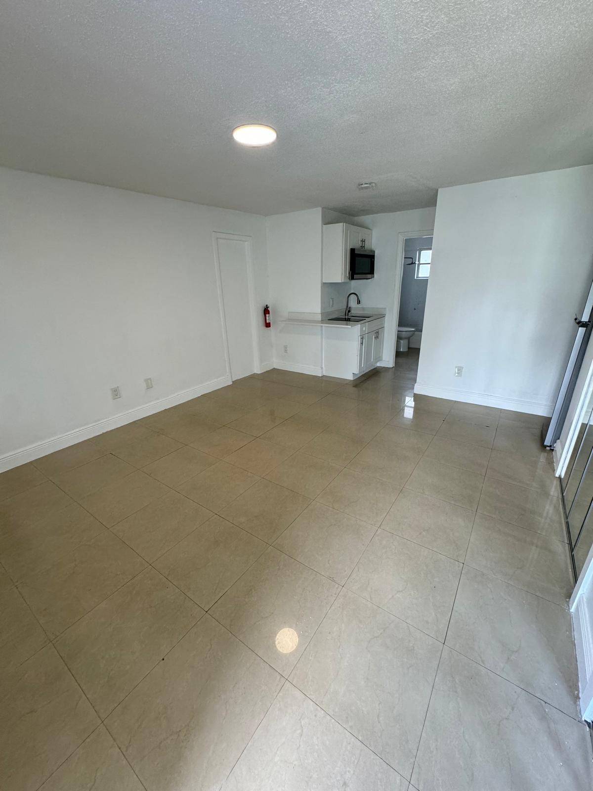 512 Southwest 2nd Street, Unit A Hallandale Beach, FL 33009 - Photo 2 of 13 a view of kitchen and white cabinets