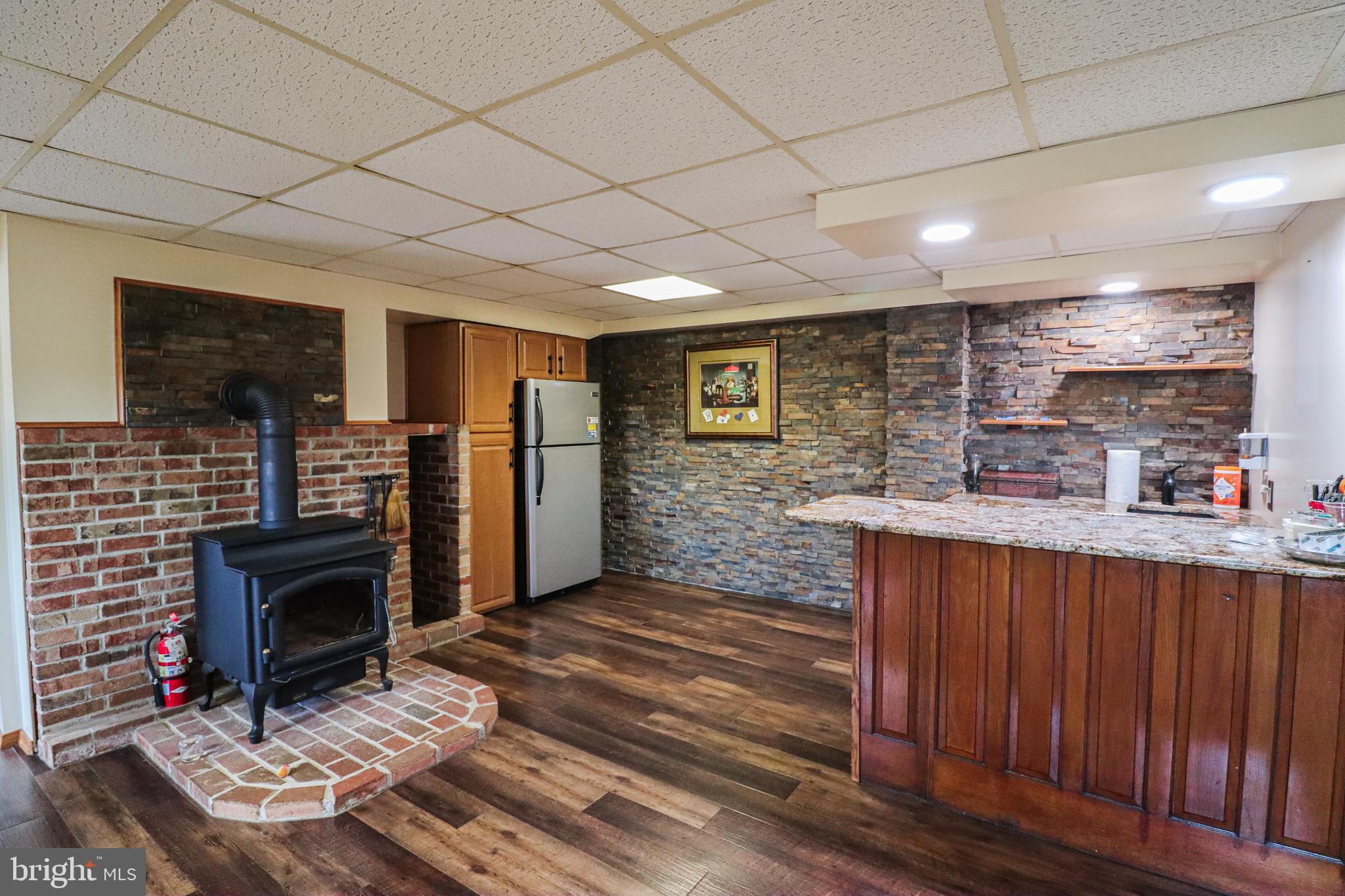 170 Donrene Road Mount Wolf, PA 17347 - Photo 16 of 71 a living room with stainless steel appliances furniture a fireplace and a projector screen