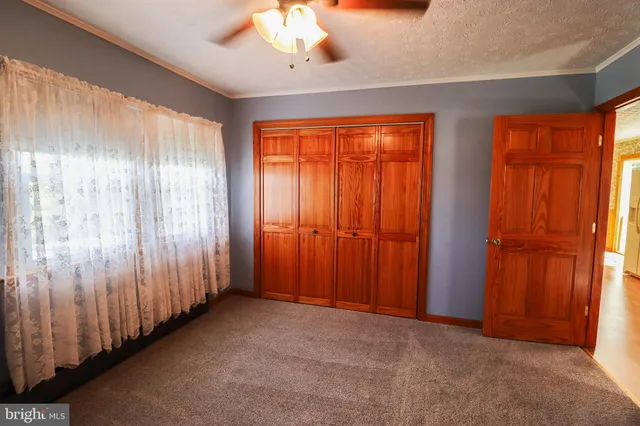 a view of a kitchen with a fridge and wooden floor