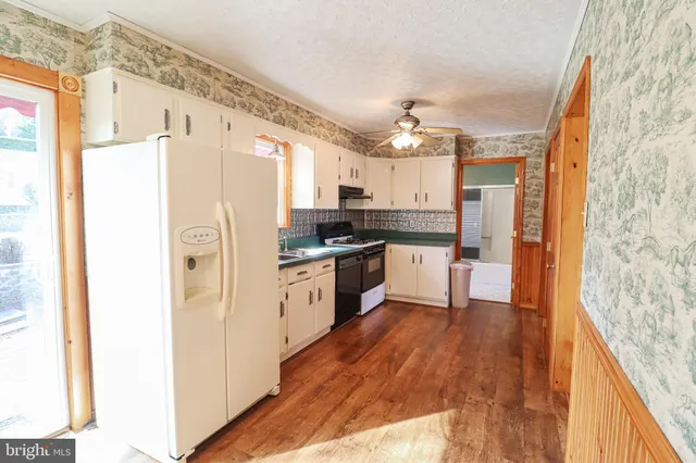 a kitchen with stainless steel appliances granite countertop a stove and a refrigerator