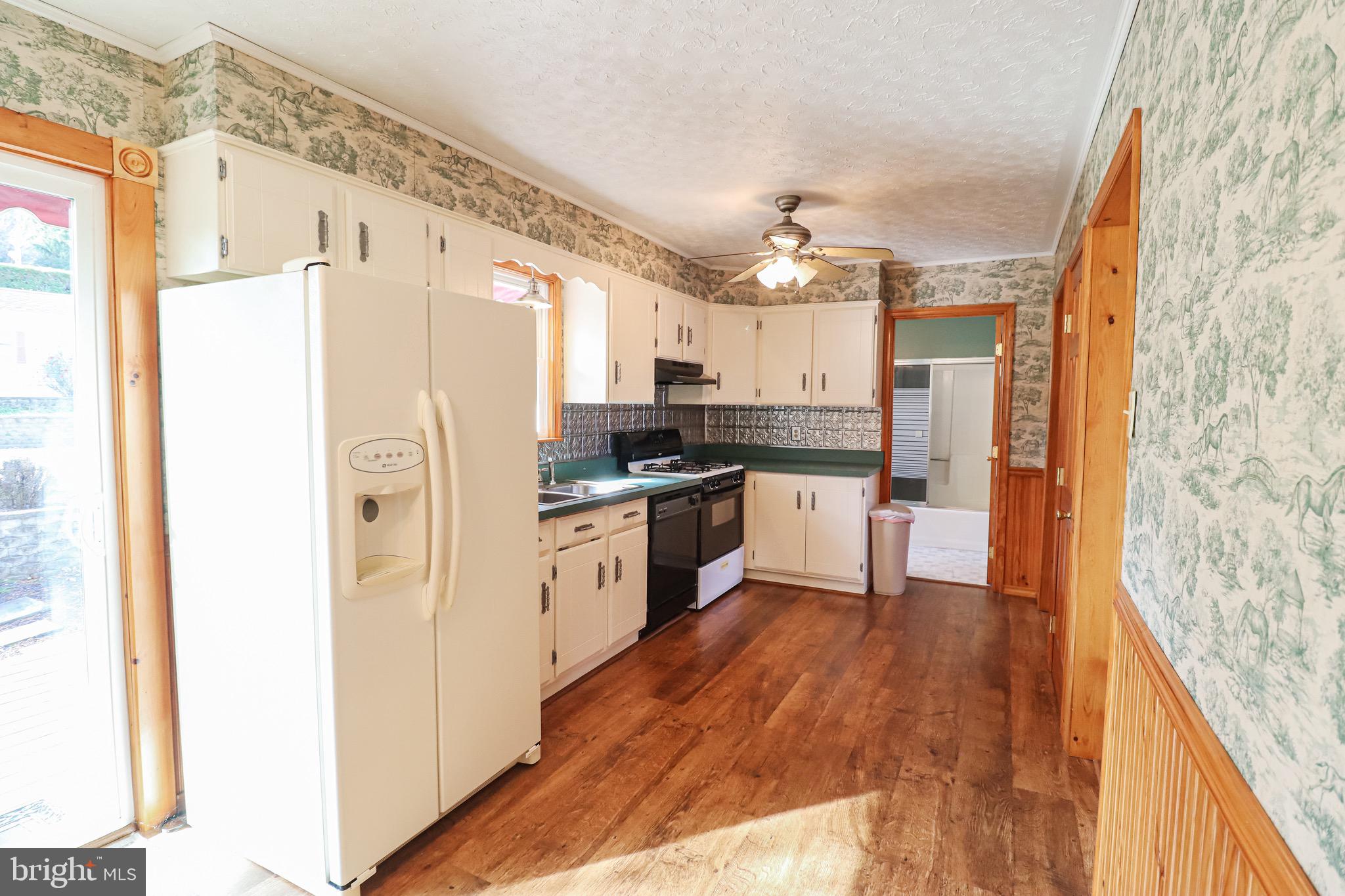 170 Donrene Road Mount Wolf, PA 17347 - Photo 35 of 71 a kitchen with granite countertop a refrigerator a sink and white cabinets
