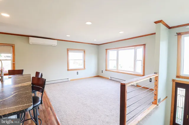 a view of a room with window and wooden floor