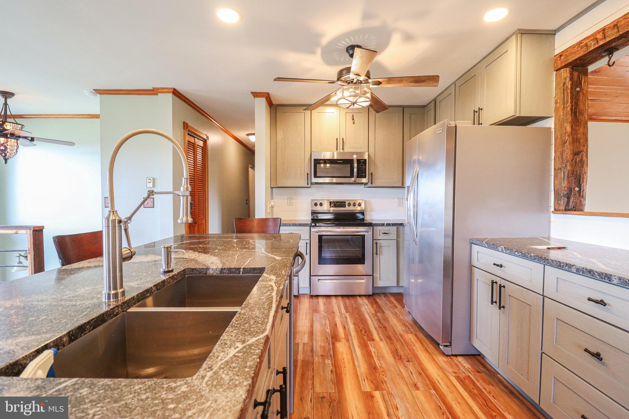 170 Donrene Road Mount Wolf, PA 17347 - Photo 8 of 71 a kitchen with a sink a counter top space stainless steel appliances and a window