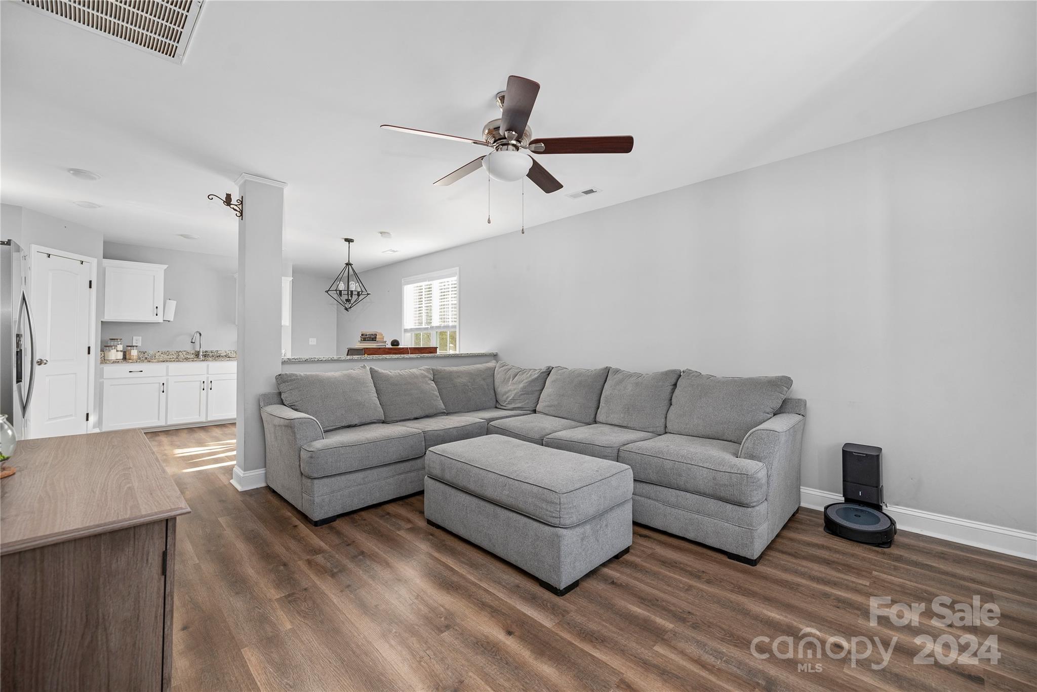 283 Sunderland Road Southwest Concord, NC 28027 - Photo 11 of 27 a living room with couches and kitchen view with wooden floor