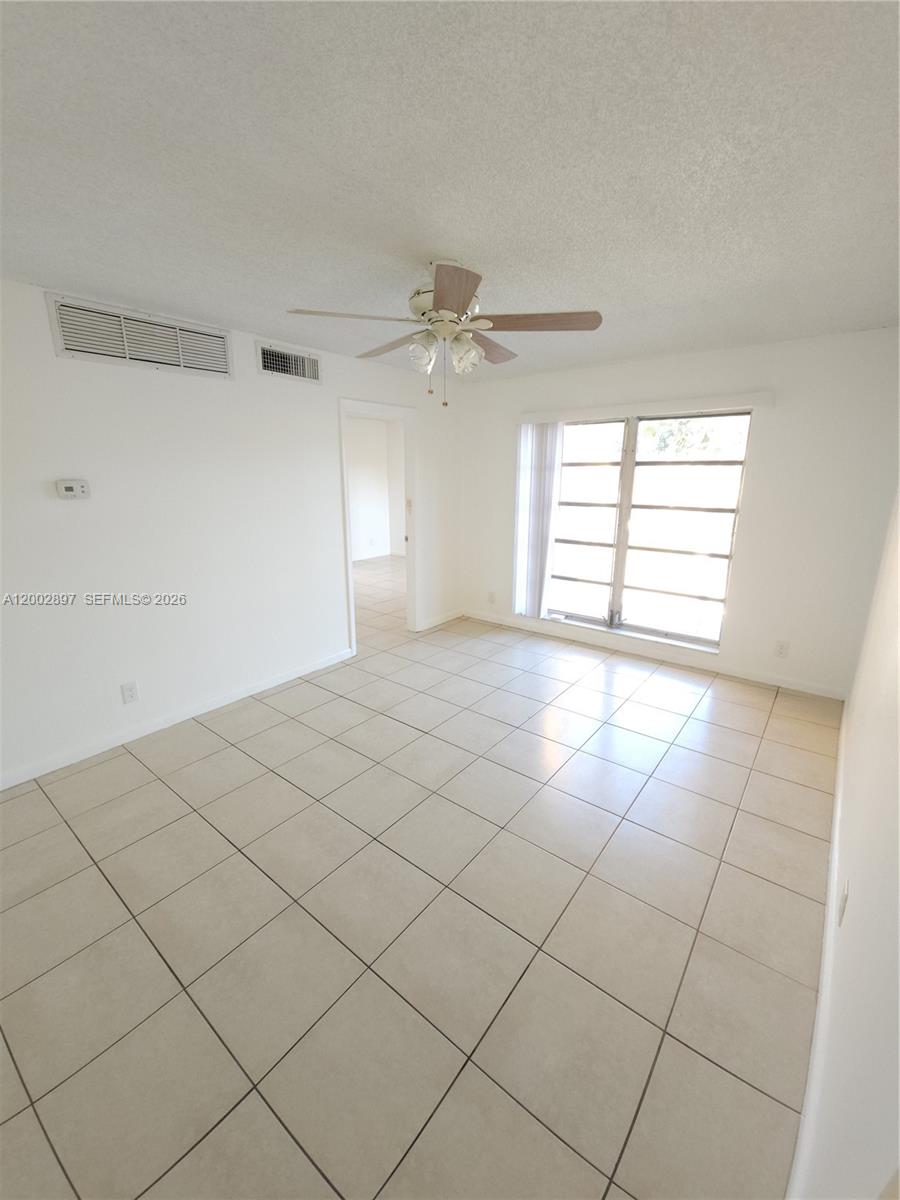 4505 Treehouse Lane, Unit 8H Tamarac, FL 33319 - Photo 1 of 29 a view of an empty room and a window
