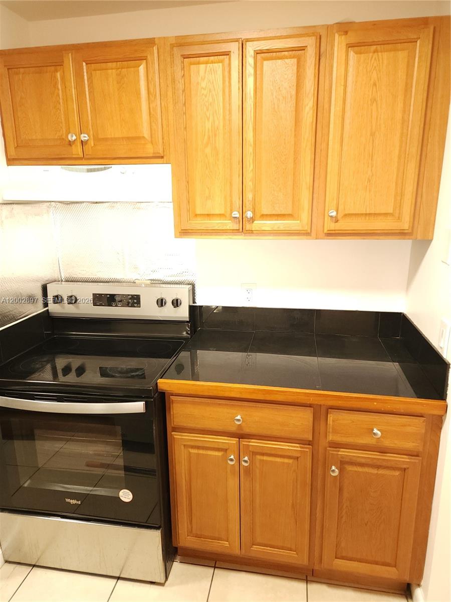 4505 Treehouse Lane, Unit 8H Tamarac, FL 33319 - Photo 12 of 29 a close view of a sink and a dishwasher in a kitchen