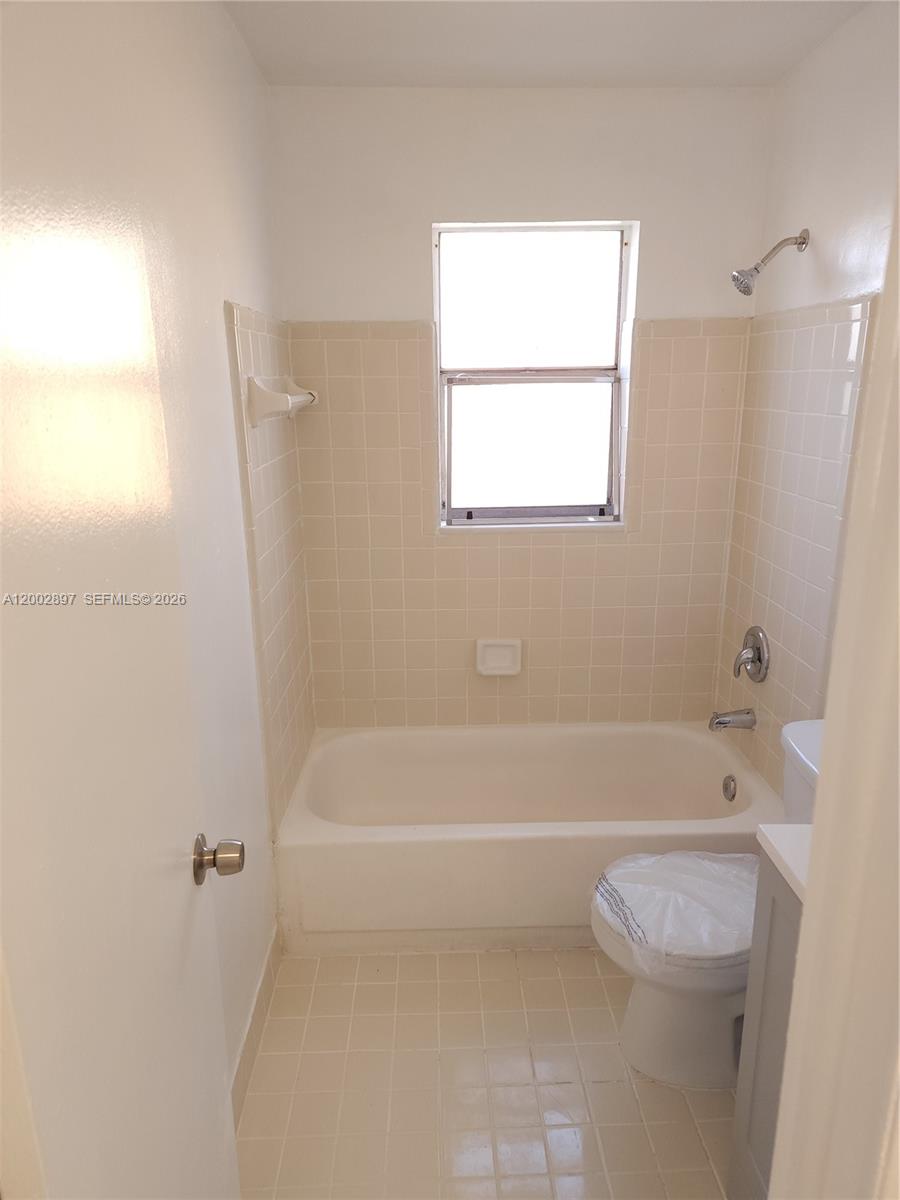 4505 Treehouse Lane, Unit 8H Tamarac, FL 33319 - Photo 18 of 29 a bathroom with a bathtub and a toilet