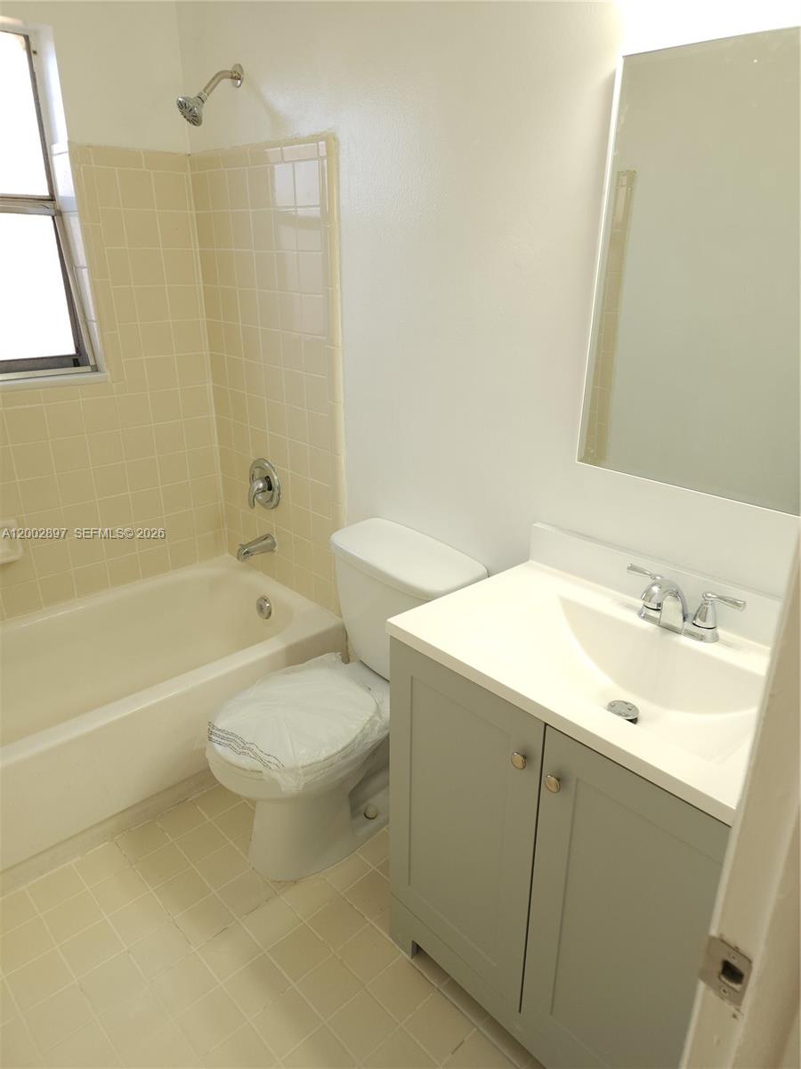 4505 Treehouse Lane, Unit 8H Tamarac, FL 33319 - Photo 19 of 29 a bathroom with a sink a toilet and bathtub