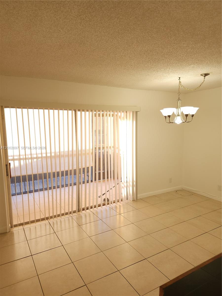 4505 Treehouse Lane, Unit 8H Tamarac, FL 33319 - Photo 20 of 29 a view of an empty room with a window