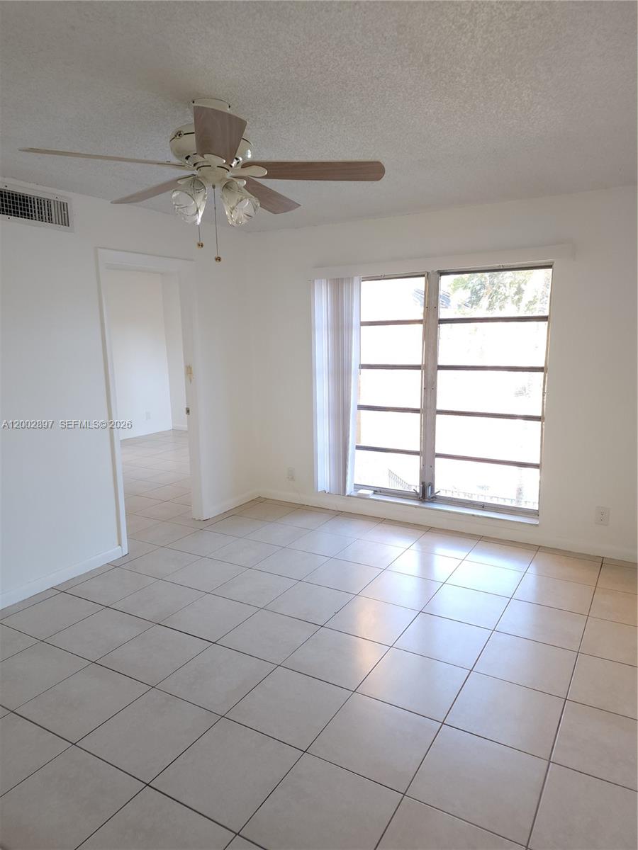 4505 Treehouse Lane, Unit 8H Tamarac, FL 33319 - Photo 2 of 29 a view of an empty room with a window
