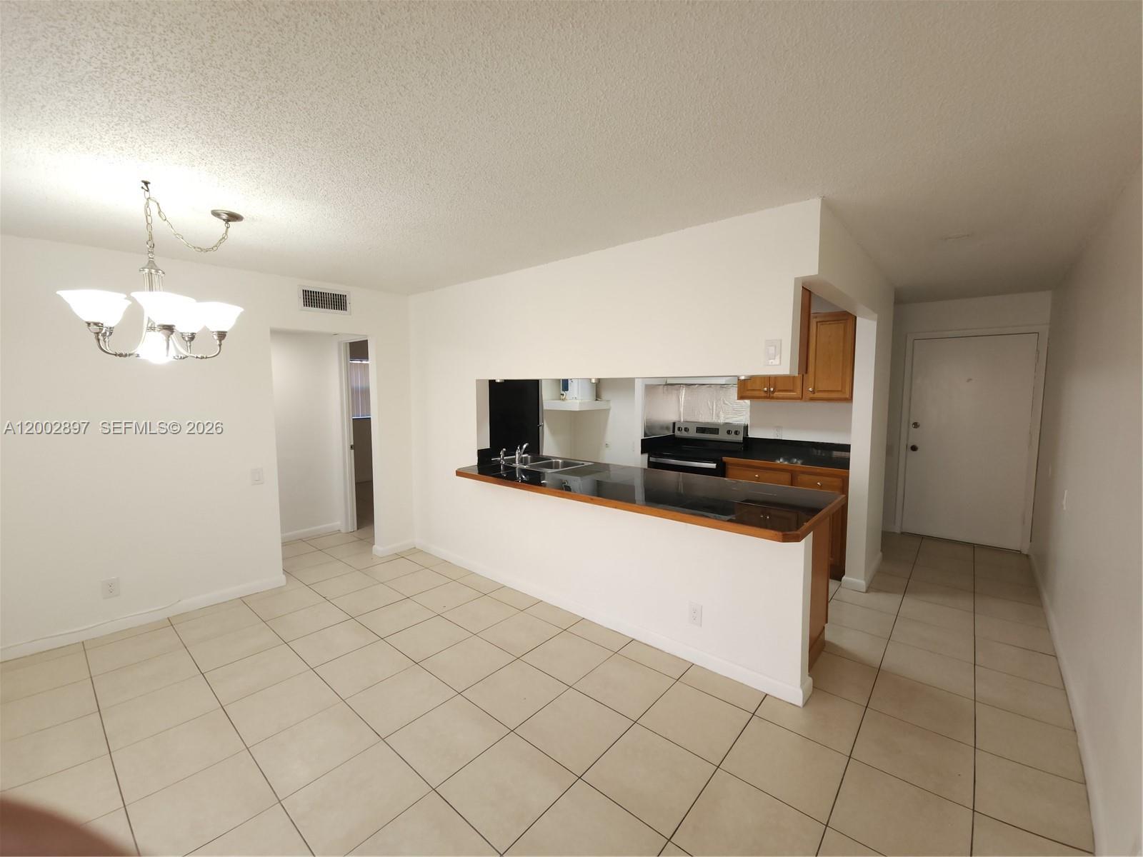 4505 Treehouse Lane, Unit 8H Tamarac, FL 33319 - Photo 21 of 29 a large kitchen with cabinets and stainless steel appliances