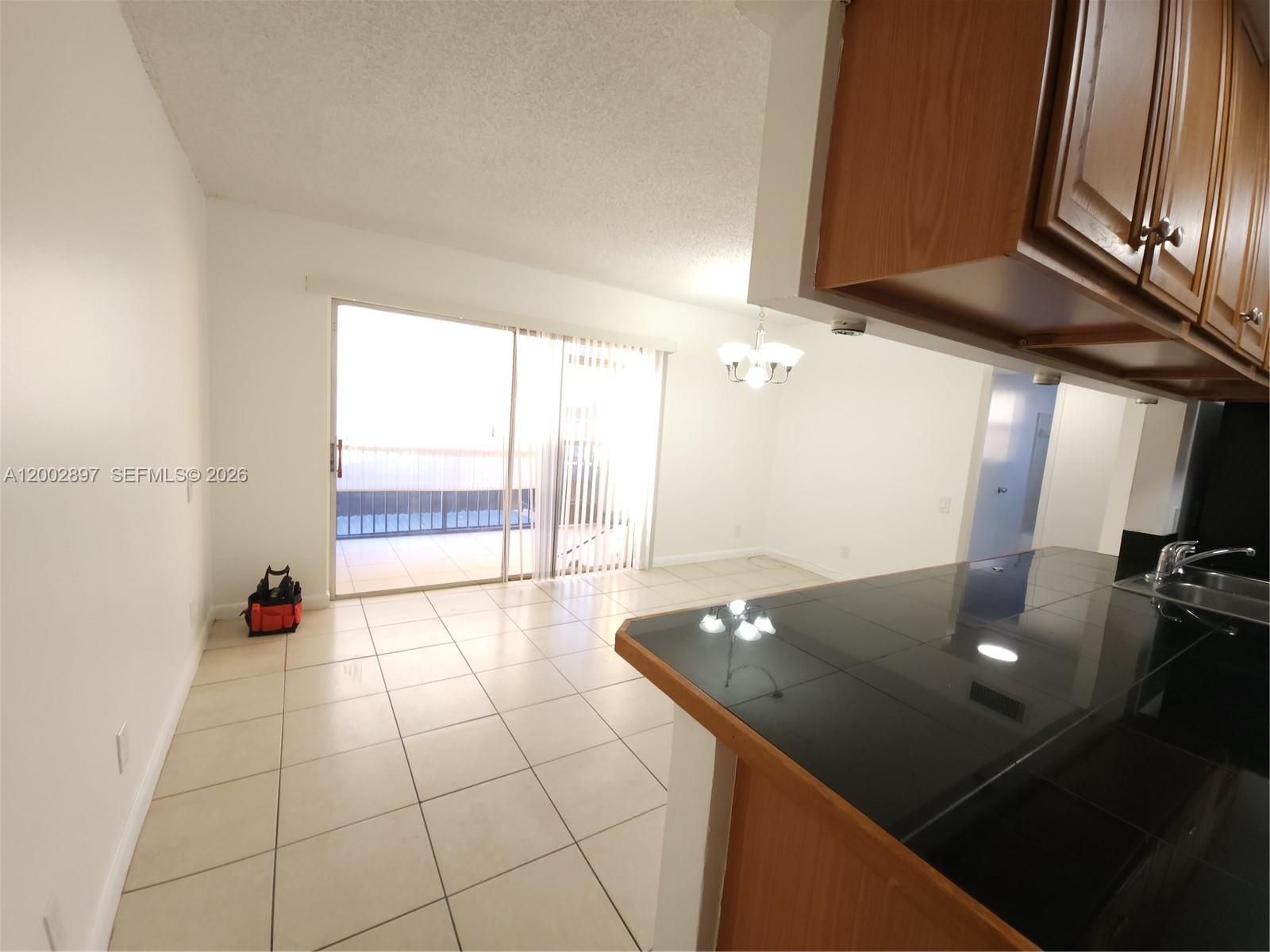 4505 Treehouse Lane, Unit 8H Tamarac, FL 33319 - Photo 22 of 29 a open kitchen with a large window