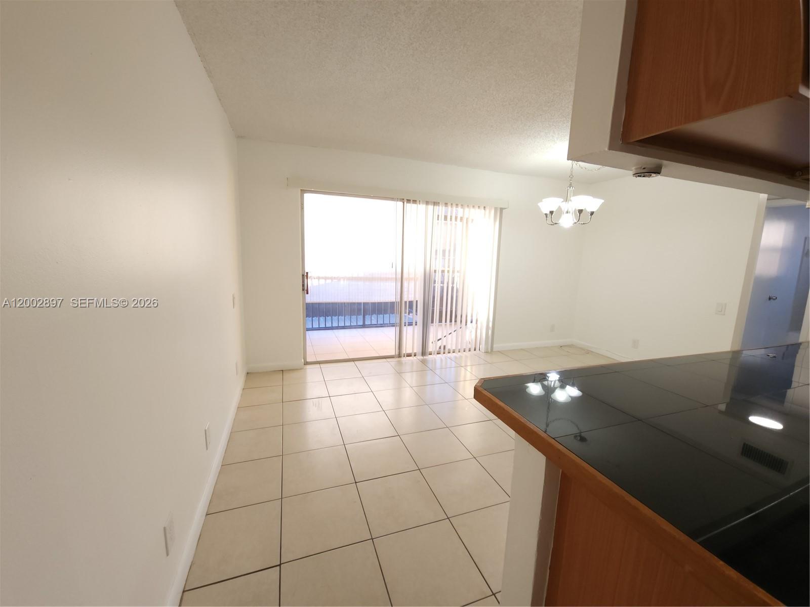 4505 Treehouse Lane, Unit 8H Tamarac, FL 33319 - Photo 23 of 29 a view of an empty room and window