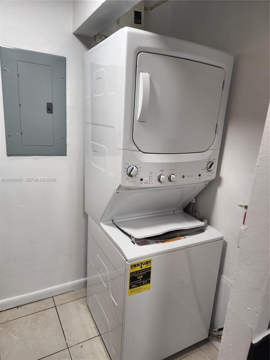 4505 Treehouse Lane, Unit 8H Tamarac, FL 33319 - Photo 27 of 29 a utility room with wooden floor washer and dryer