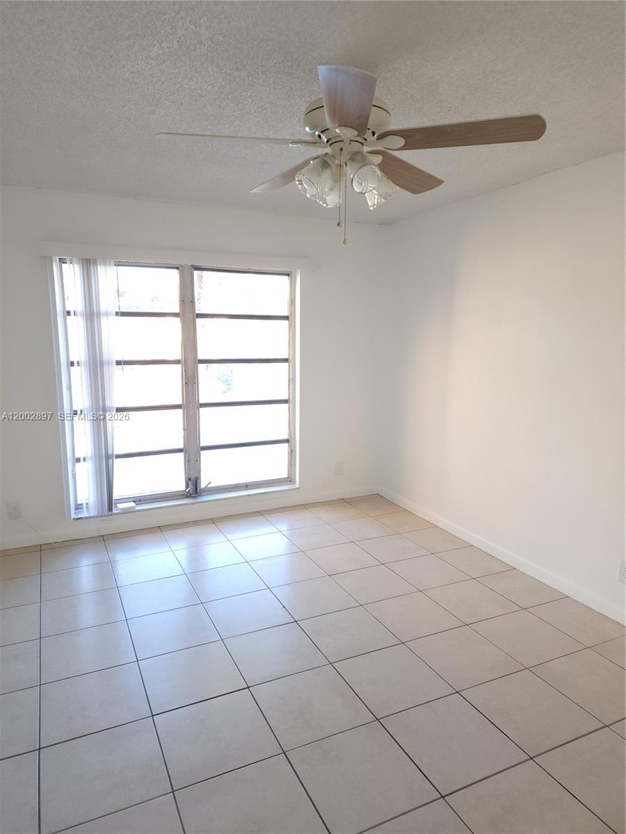 4505 Treehouse Lane, Unit 8H Tamarac, FL 33319 - Photo 3 of 29 a view of an empty room with a window