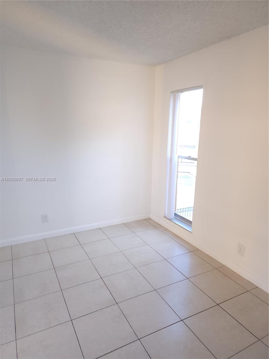 4505 Treehouse Lane, Unit 8H Tamarac, FL 33319 - Photo 6 of 29 an empty room with windows
