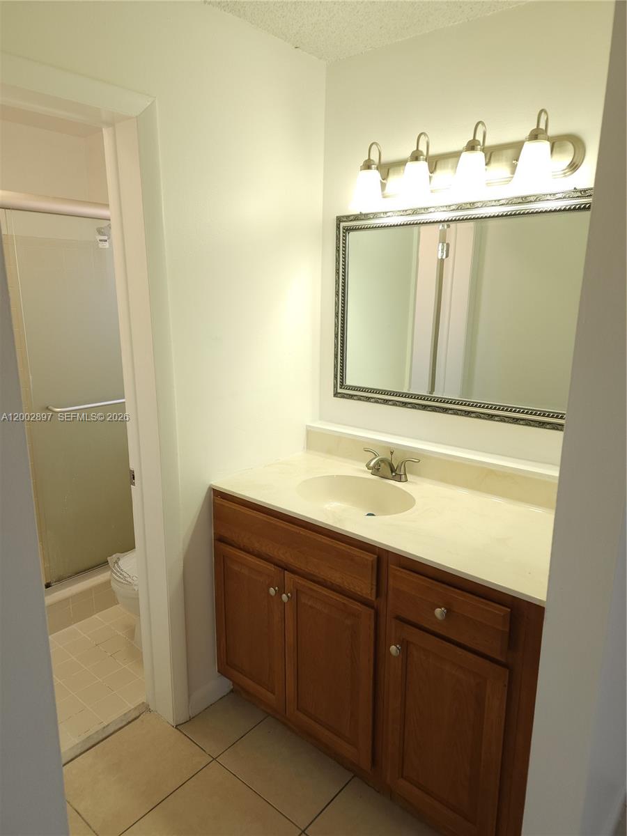 4505 Treehouse Lane, Unit 8H Tamarac, FL 33319 - Photo 8 of 29 a bathroom with a sink and mirror