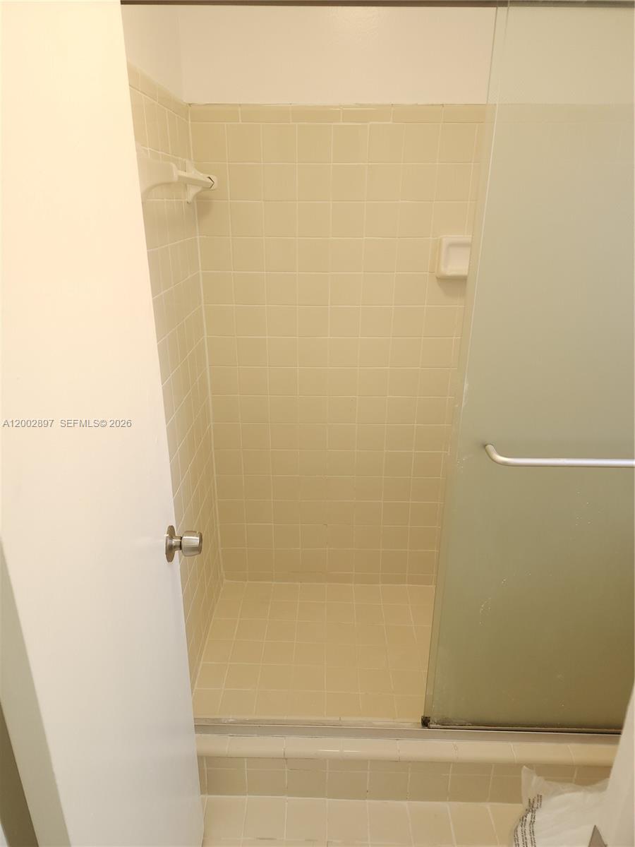 4505 Treehouse Lane, Unit 8H Tamarac, FL 33319 - Photo 10 of 29 a bathroom with a bathtub