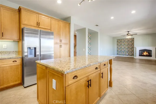 a kitchen with stainless steel appliances granite countertop a sink and a refrigerator