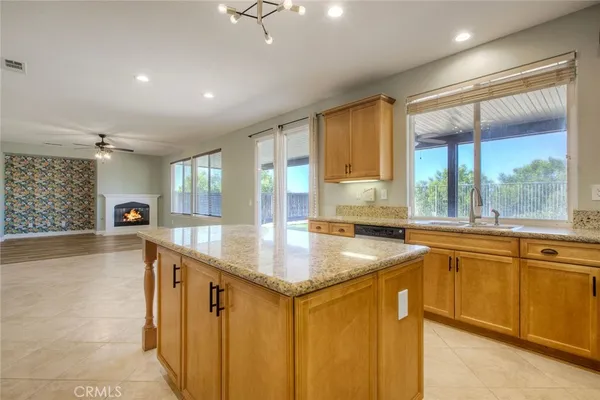 a kitchen with stainless steel appliances granite countertop sink stove and refrigerator