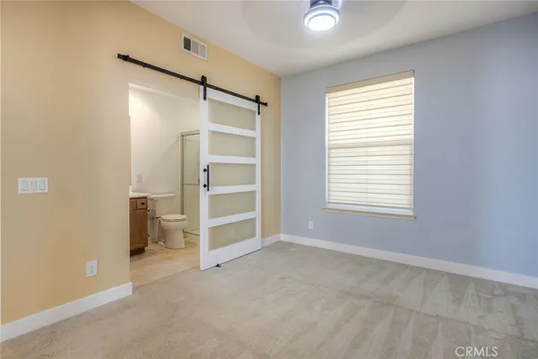 a view of empty room with window and cabinet