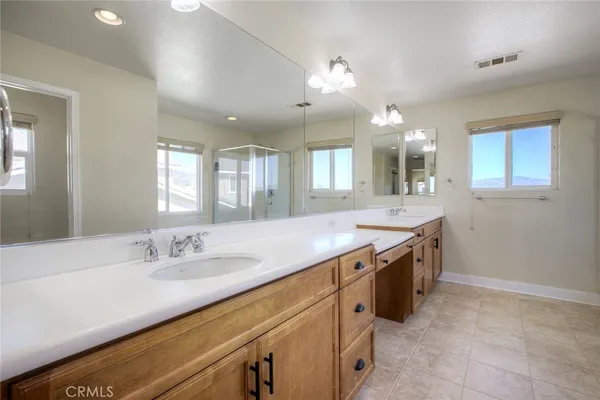 a bathroom with a sink vanity and mirror