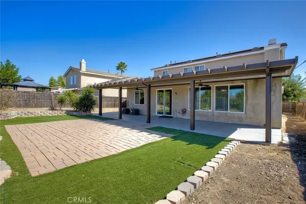 a view of a house with a yard and sitting area