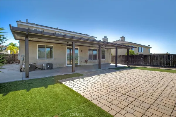 a view of a house with backyard and sitting area