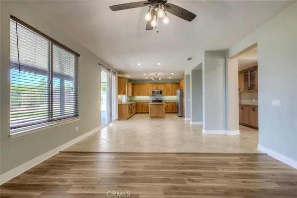 a view of kitchen and hall with wooden floor