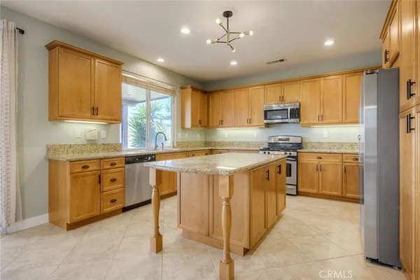 a kitchen with stainless steel appliances granite countertop a stove and a sink