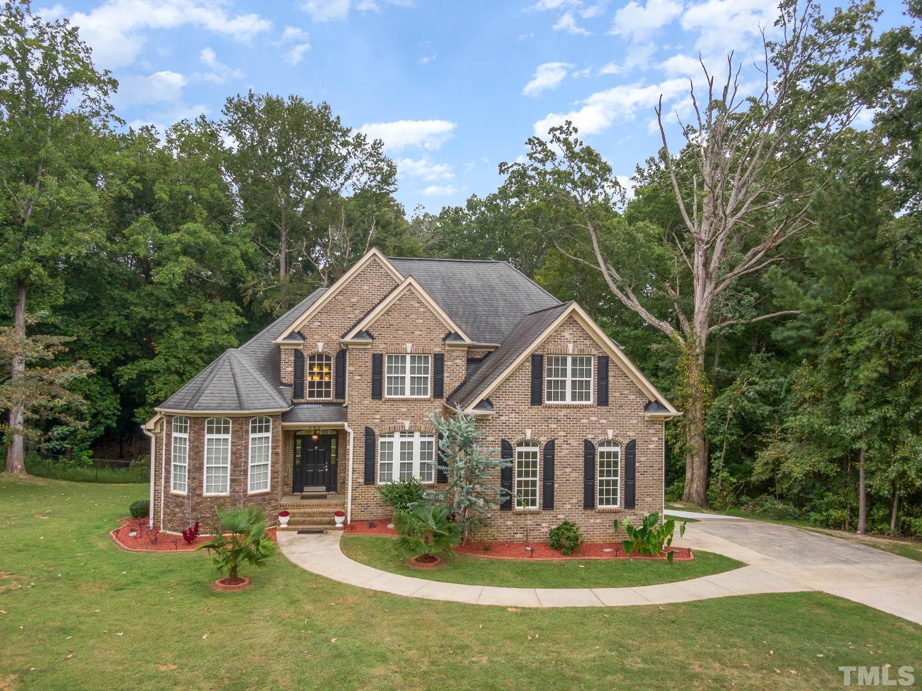 a front view of a house with a yard table and chairs