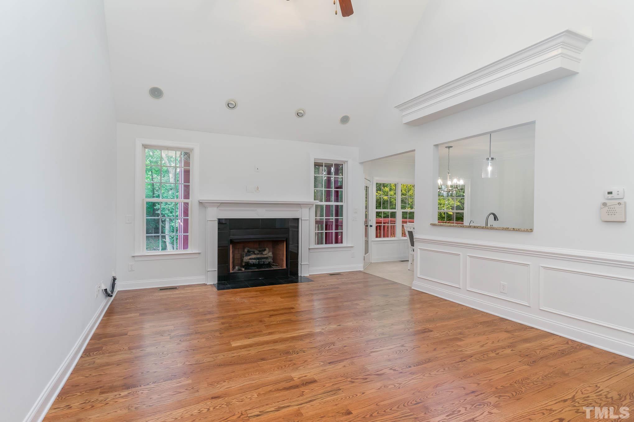 320 Government Road Clayton, NC 27520 - Photo 11 of 48 a view of an empty room with a fireplace and a window