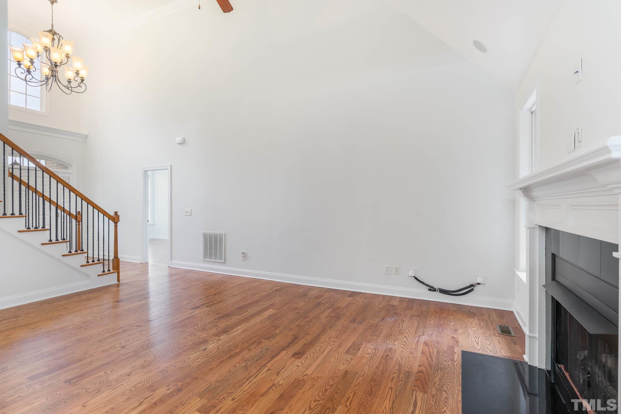 320 Government Road Clayton, NC 27520 - Photo 12 of 48 a view of an empty room with wooden floor and a fireplace